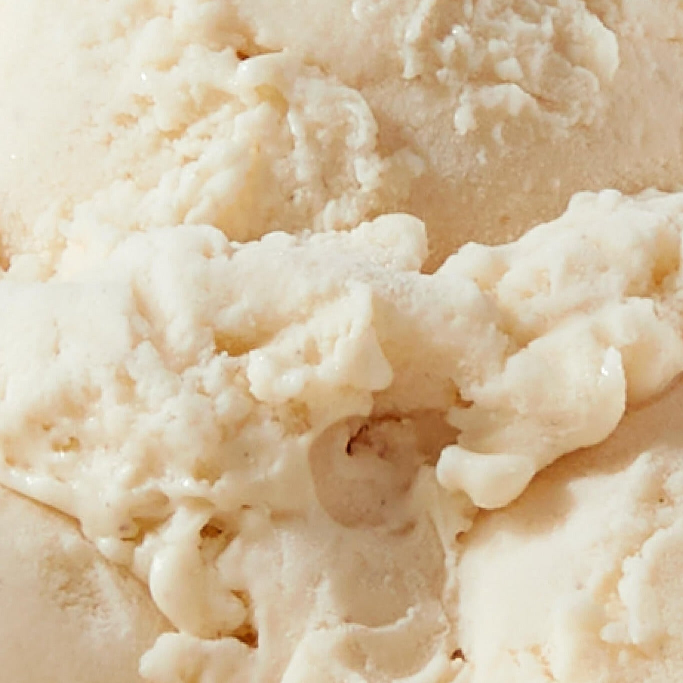 Extreme close-up texture shot of N!CK'S Vanilla Bean light ice cream, showing the creamy, pale texture of the vanilla-flavored dessert.