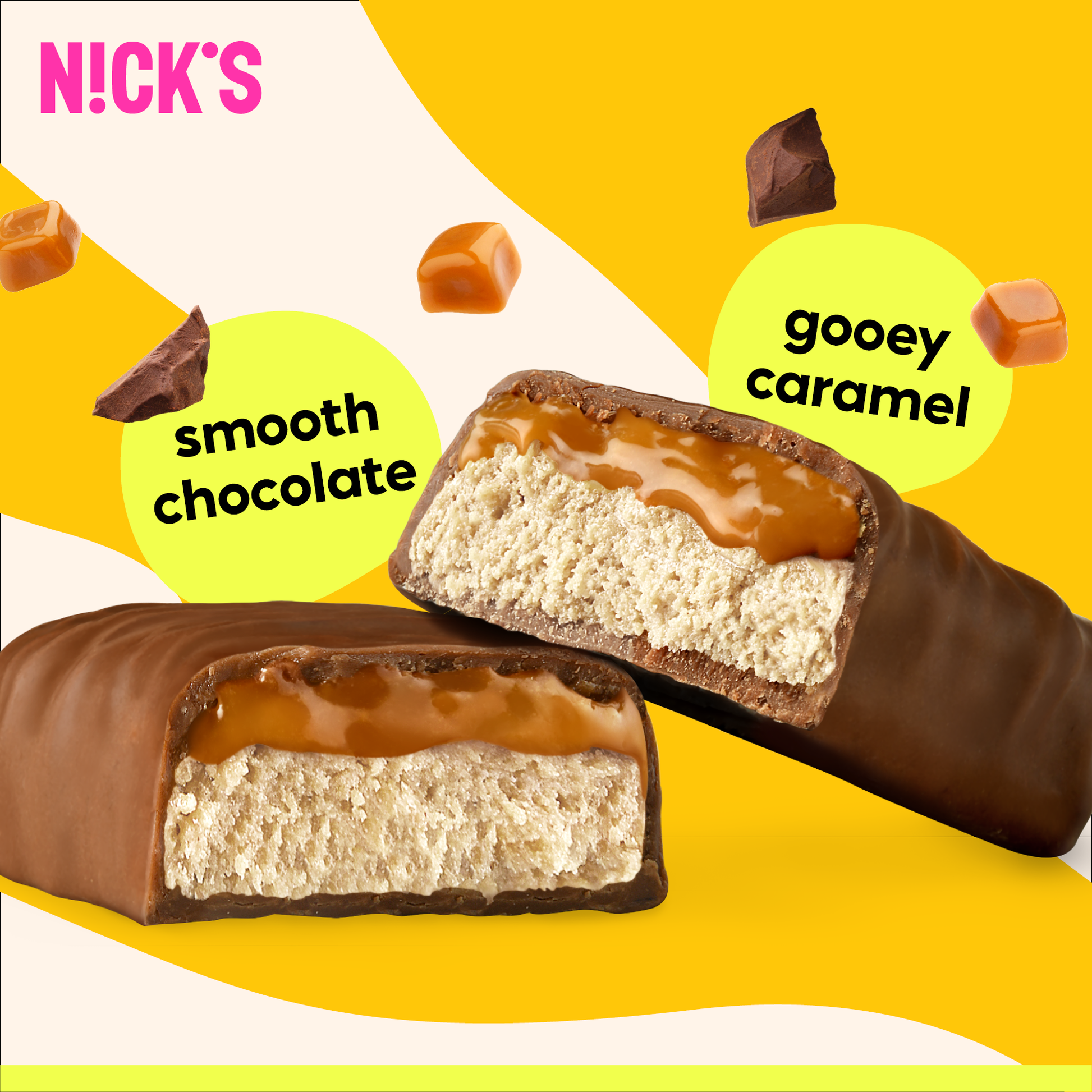Close-up cross-section of a N!CK'S Caramel Chocolate Protein Bar, clearly showing gooey caramel over a soft protein base, coated in smooth chocolate.