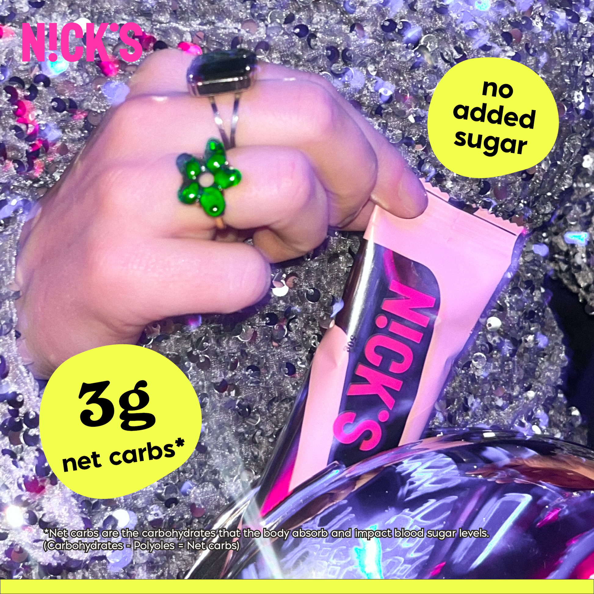 Close-up of a hand with rings holding a N!CK'S Salty Peanut Protein Bar wrapper against a sparkly, sequined background. Text highlights '3g net carbs*' and 'no added sugar' for this keto-friendly bar.